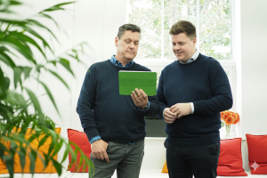 image of mayden colleagues looking at an ipad